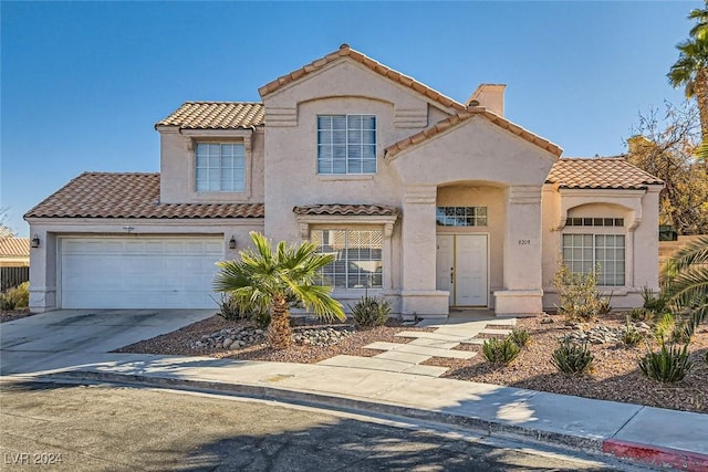 mediterranean / spanish-style home with a garage