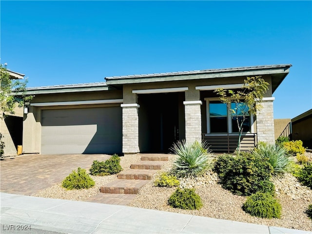 prairie-style home featuring a garage