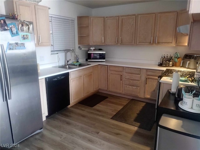 kitchen featuring light brown cabinetry, light hardwood / wood-style floors, sink, and stainless steel appliances