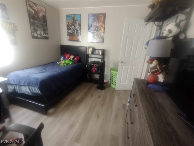 bedroom with hardwood / wood-style flooring