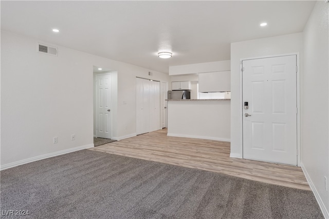 unfurnished living room featuring light hardwood / wood-style floors