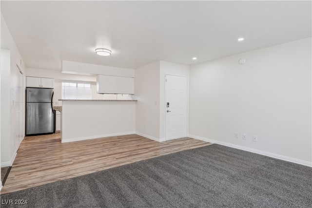 unfurnished living room featuring light wood-type flooring