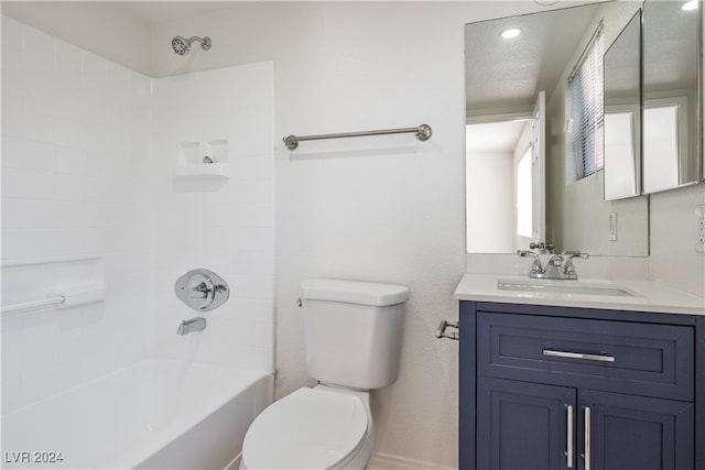 full bathroom featuring vanity, a textured ceiling, washtub / shower combination, and toilet