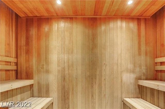 view of sauna / steam room with wood ceiling and wooden walls