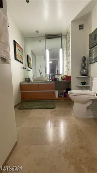 bathroom featuring vanity and toilet