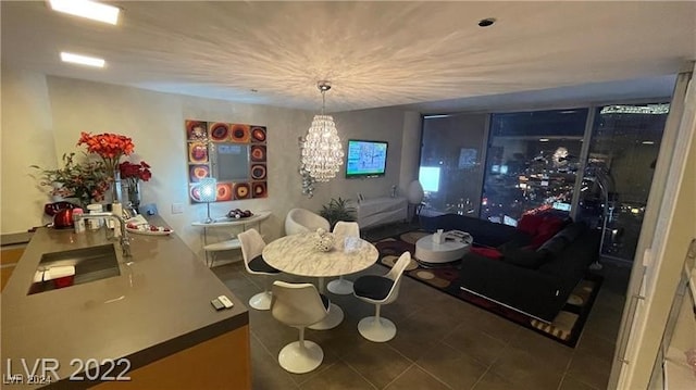 living room featuring an inviting chandelier, sink, and tile patterned floors