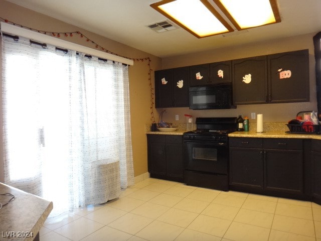 kitchen with dark brown cabinetry and black appliances