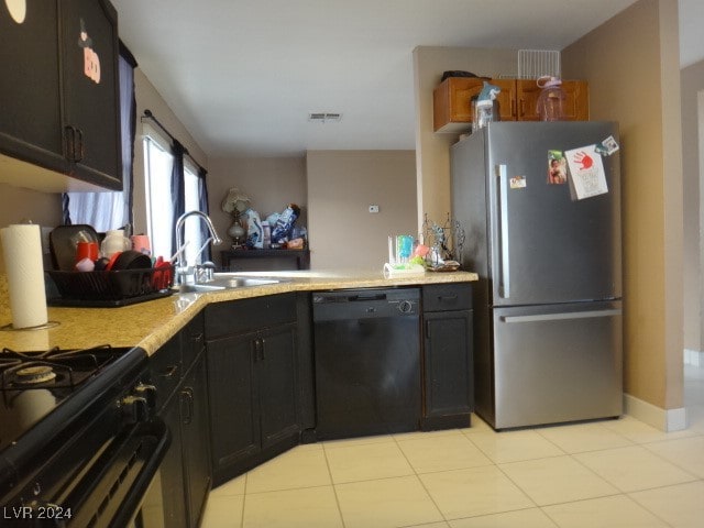 kitchen with sink, light tile patterned floors, kitchen peninsula, and black appliances