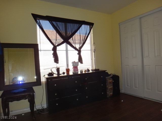 bedroom with a closet and dark hardwood / wood-style floors