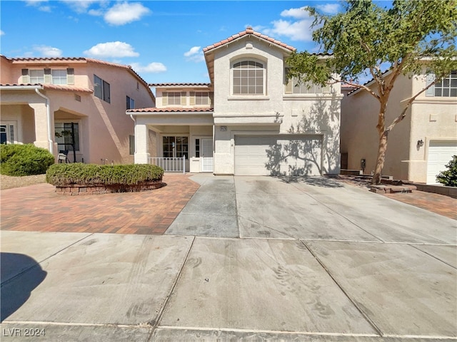 mediterranean / spanish house featuring a garage