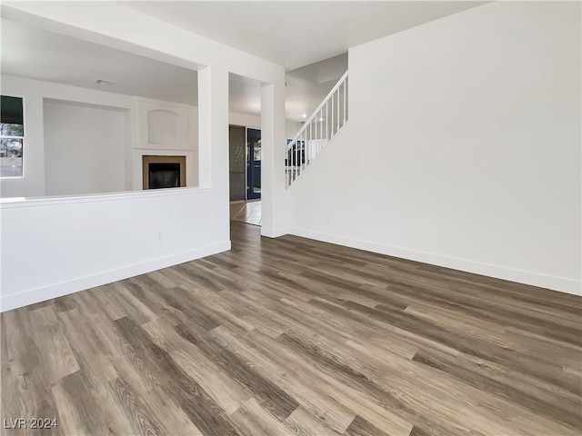 unfurnished living room with wood-type flooring