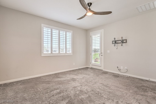 carpeted empty room featuring ceiling fan