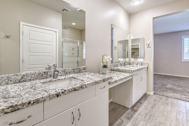 bathroom featuring vanity, a shower with door, and hardwood / wood-style flooring