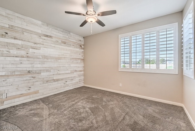 unfurnished room with ceiling fan and carpet flooring