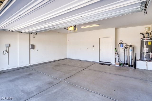 garage with a garage door opener and water heater