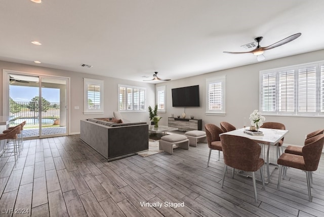 living room with ceiling fan, light hardwood / wood-style floors, and a wealth of natural light