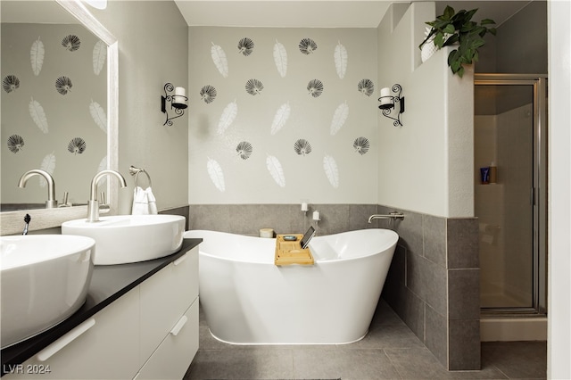 bathroom featuring vanity, tile walls, tile patterned flooring, and plus walk in shower