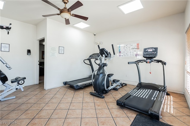 workout room featuring ceiling fan and light tile patterned flooring