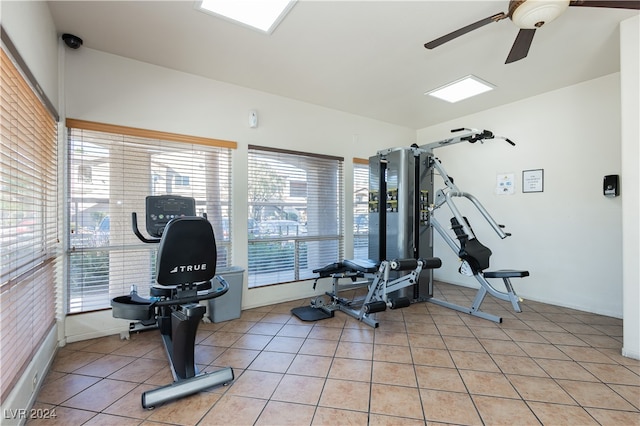 gym with ceiling fan and light tile patterned floors