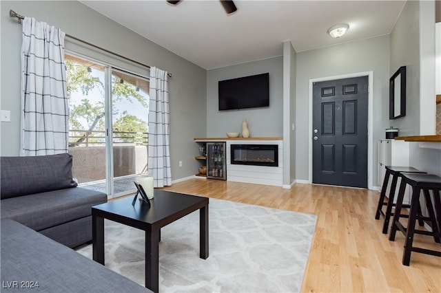 living room with hardwood / wood-style flooring and beverage cooler