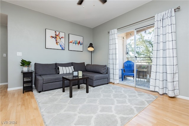 living room featuring ceiling fan and hardwood / wood-style floors