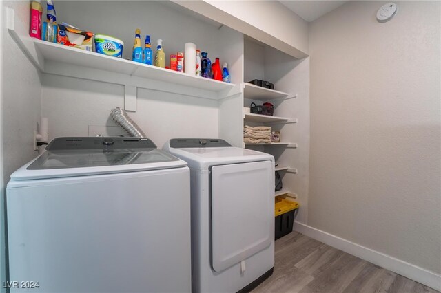 laundry room featuring wood-type flooring and washing machine and dryer