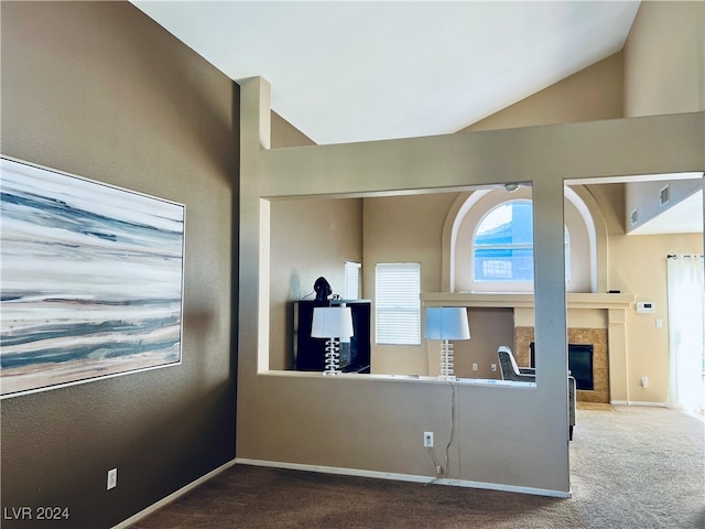 kitchen with carpet, a fireplace, and vaulted ceiling