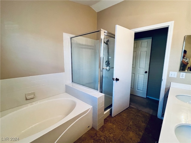 bathroom with shower with separate bathtub, vanity, vaulted ceiling, and tile patterned floors