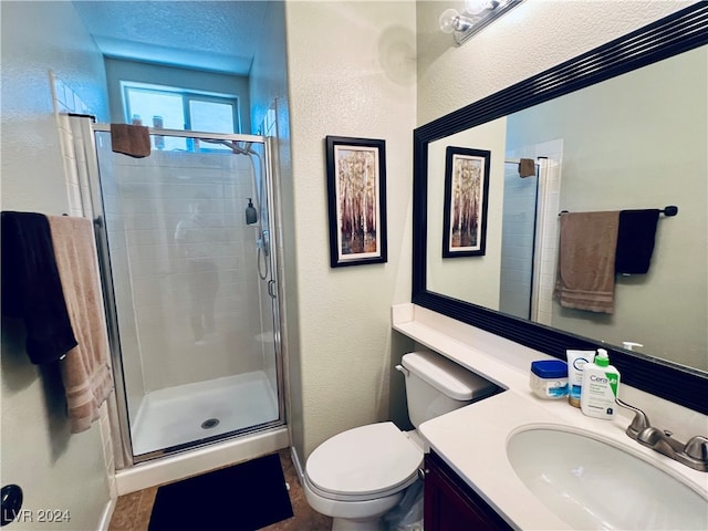 bathroom with walk in shower, vanity, and toilet