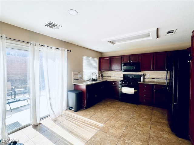 kitchen with decorative backsplash, black appliances, a healthy amount of sunlight, and sink