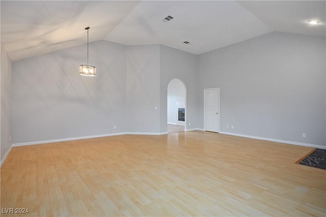 unfurnished living room featuring light wood-type flooring and lofted ceiling