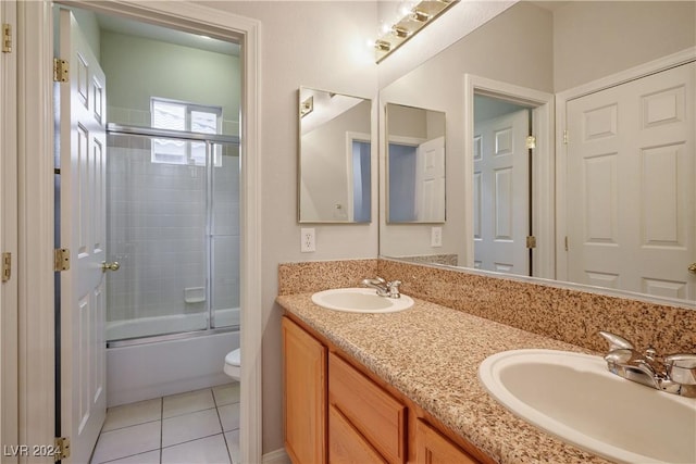 full bathroom featuring tile patterned flooring, vanity, toilet, and enclosed tub / shower combo