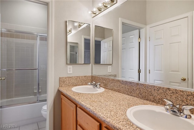 full bathroom with tile patterned floors, vanity, toilet, and shower / bath combination with glass door