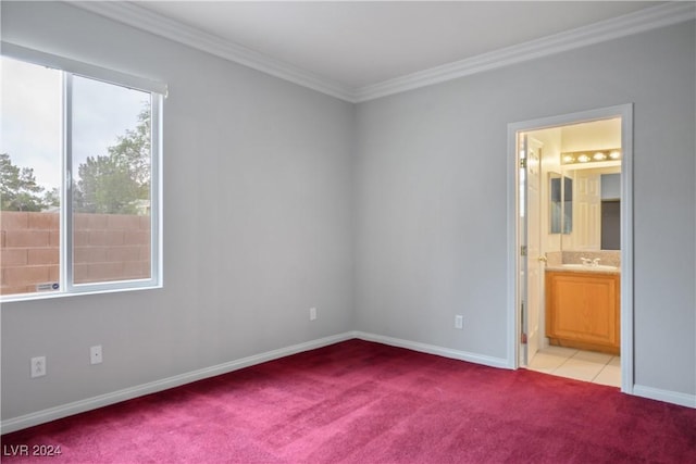 unfurnished bedroom with light colored carpet, ensuite bath, crown molding, and sink