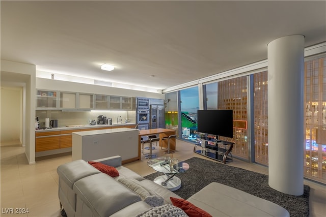 living room featuring light tile patterned flooring and floor to ceiling windows