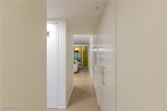 hall with light tile patterned floors