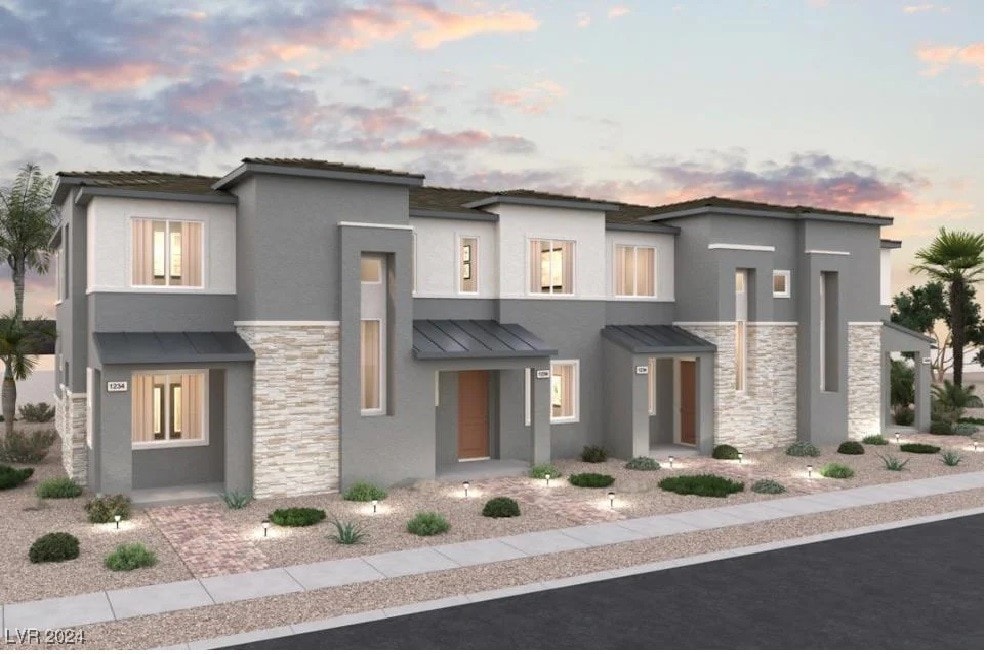 986 Gearus Pl, Henderson, NV 89011 - view of front facade with a standing seam roof, metal roof, stucco siding, and stone siding