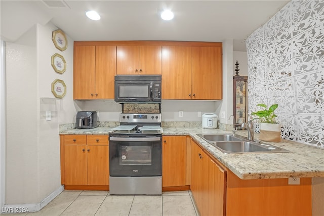 kitchen featuring light stone counters, kitchen peninsula, stainless steel range with electric stovetop, light tile patterned floors, and sink