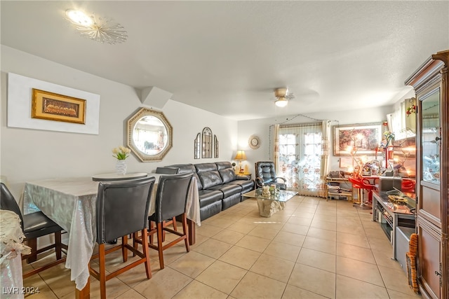 dining space featuring ceiling fan and light tile patterned floors