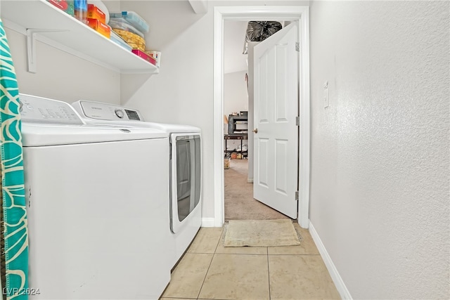 washroom with washing machine and clothes dryer and light tile patterned floors