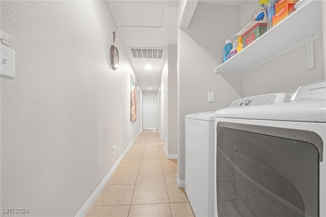 clothes washing area featuring light tile patterned floors and independent washer and dryer