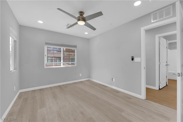 unfurnished room featuring light hardwood / wood-style floors and ceiling fan