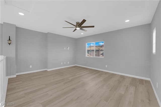 spare room with light wood-type flooring and ceiling fan