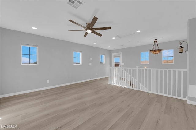 empty room with light wood-type flooring and a healthy amount of sunlight