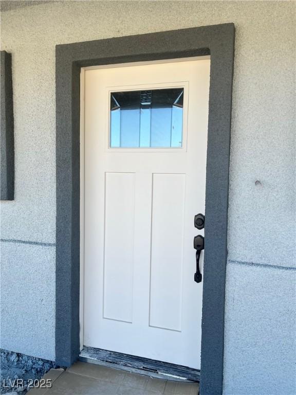 view of exterior entry with stucco siding