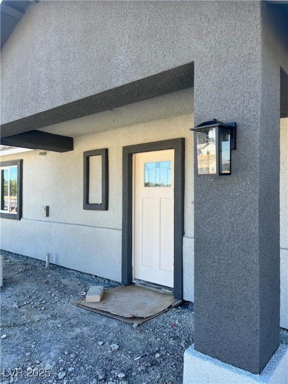 property entrance with stucco siding