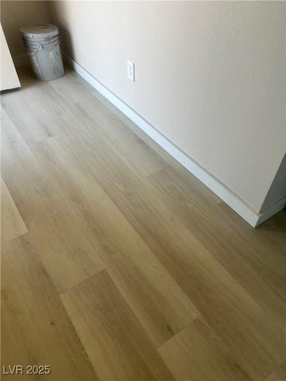 room details with baseboards and wood finished floors