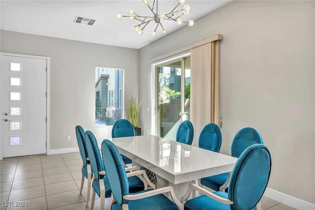 tiled dining space featuring a chandelier