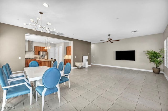 dining space featuring ceiling fan with notable chandelier and light tile patterned floors