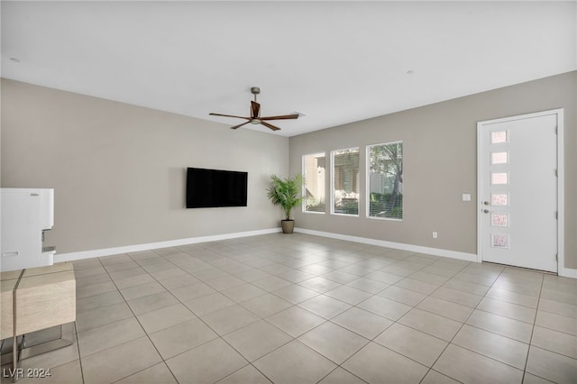 unfurnished living room with light tile patterned floors and ceiling fan